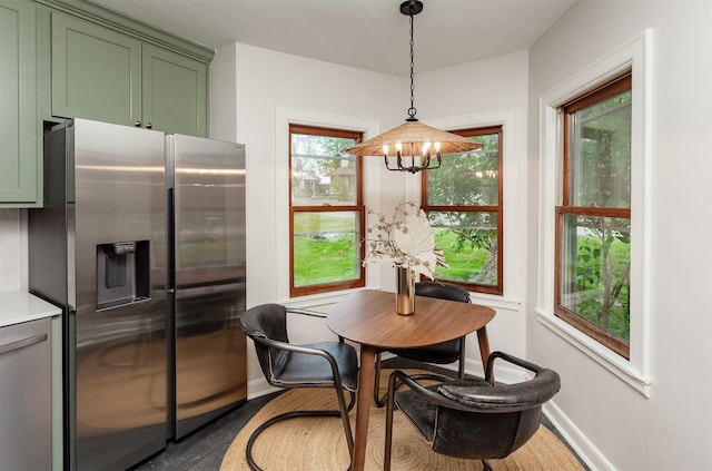16 E Leach Ave, Des Moines, IA 50315 - dining space featuring baseboards and a chandelier
