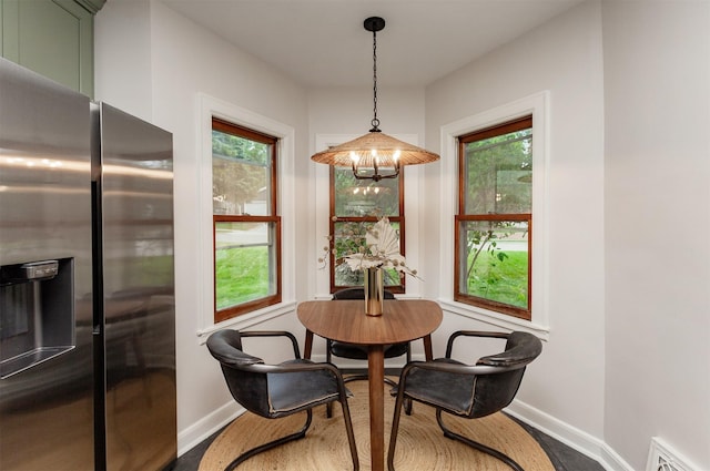 16 E Leach Ave, Des Moines, IA 50315 - dining area featuring plenty of natural light and wood finished floors