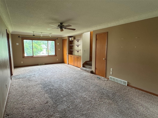 2601 Sherwood Dr, Des Moines, IA 50310 - unfurnished bedroom featuring carpet, a textured ceiling, ornamental molding, and a ceiling fan