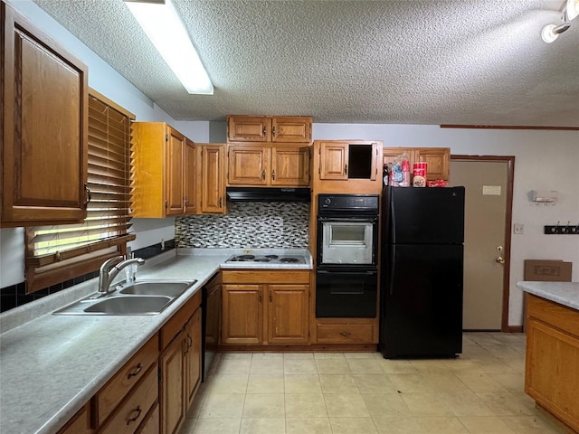 2601 Sherwood Dr, Des Moines, IA 50310 - kitchen with black appliances, a textured ceiling, light countertops, brown cabinetry, and range hood