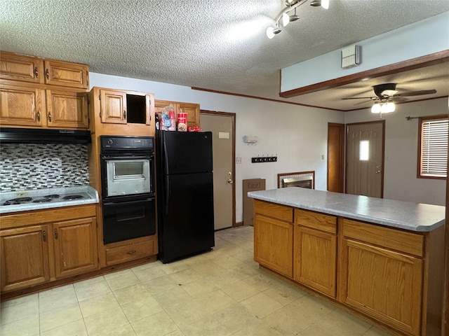 2601 Sherwood Dr, Des Moines, IA 50310 - kitchen with black appliances, a textured ceiling, decorative backsplash, ceiling fan, and brown cabinetry