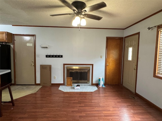 2601 Sherwood Dr, Des Moines, IA 50310 - unfurnished living room featuring light wood-type flooring, crown molding, a textured ceiling, ceiling fan, and a fireplace