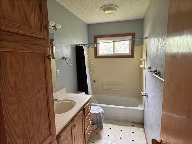 2601 Sherwood Dr, Des Moines, IA 50310 - bathroom featuring vanity, shower / bath combo, a textured ceiling, and tile patterned flooring
