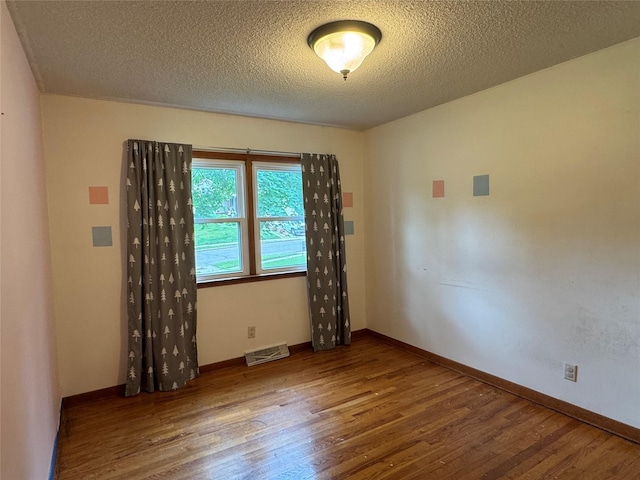 2601 Sherwood Dr, Des Moines, IA 50310 - unfurnished room featuring wood finished floors and a textured ceiling