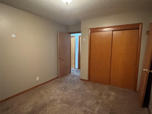 2601 Sherwood Dr, Des Moines, IA 50310 - unfurnished bedroom with carpet flooring, a textured ceiling, and a closet