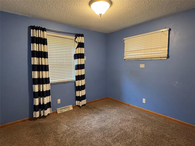 2601 Sherwood Dr, Des Moines, IA 50310 - carpeted empty room with a textured ceiling and baseboards