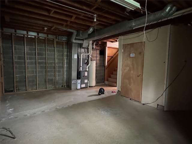 2601 Sherwood Dr, Des Moines, IA 50310 - unfinished basement featuring gas water heater, stairway, and heating unit