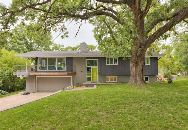6771 College Ave, Windsor Heights, IA 50324 - split foyer home featuring driveway, a garage, a chimney, and a front lawn