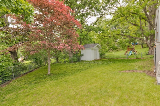 6771 College Ave, Windsor Heights, IA 50324 - fenced backyard with a storage shed and a playground