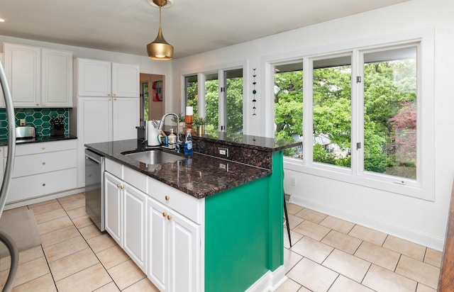 6771 College Ave, Windsor Heights, IA 50324 - kitchen featuring dishwasher, white cabinets, an island with sink, and dark stone counters