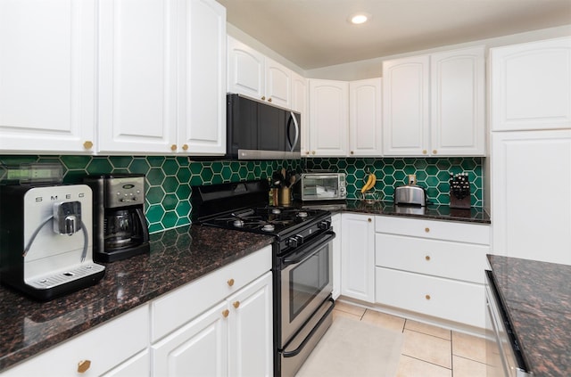 6771 College Ave, Windsor Heights, IA 50324 - kitchen featuring gas stove, black microwave, dark stone counters, white cabinets, and recessed lighting