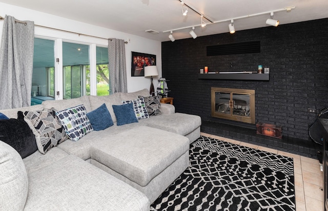 6771 College Ave, Windsor Heights, IA 50324 - living area featuring a fireplace, rail lighting, and tile patterned flooring