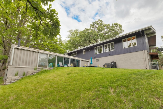 6771 College Ave, Windsor Heights, IA 50324 - rear view of property with brick siding and a yard