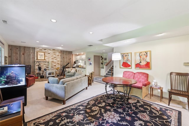 4210 Beaver Hills Dr, Des Moines, IA 50310 - carpeted living area with stairs, recessed lighting, wood walls, and a wood stove