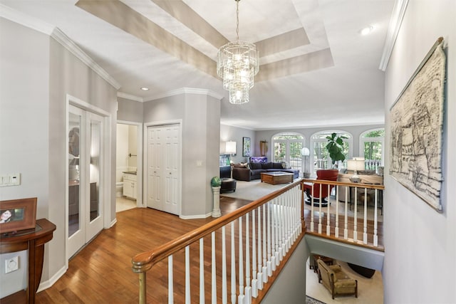 4210 Beaver Hills Dr, Des Moines, IA 50310 - staircase with wood finished floors, a chandelier, ornamental molding, recessed lighting, and a tray ceiling