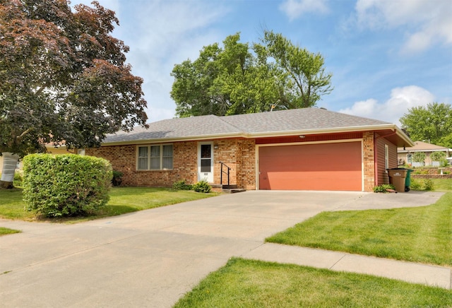 460 N 9th St, Carlisle, IA 50047 - ranch-style house featuring an attached garage, brick siding, a front lawn, driveway, and roof with shingles