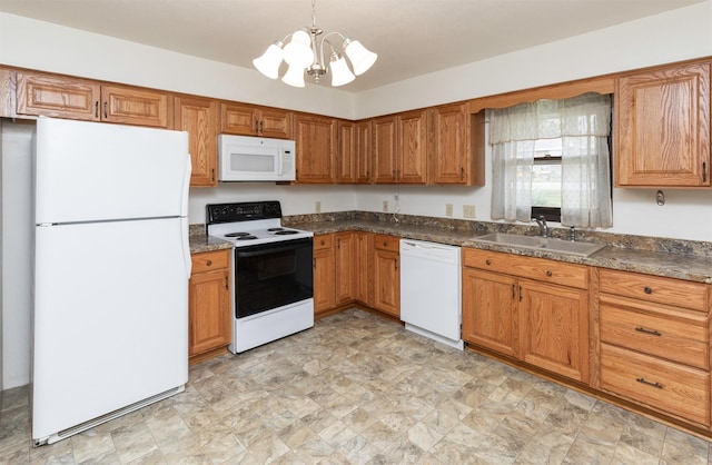 460 N 9th St, Carlisle, IA 50047 - kitchen with white appliances, a chandelier, brown cabinets, and dark countertops