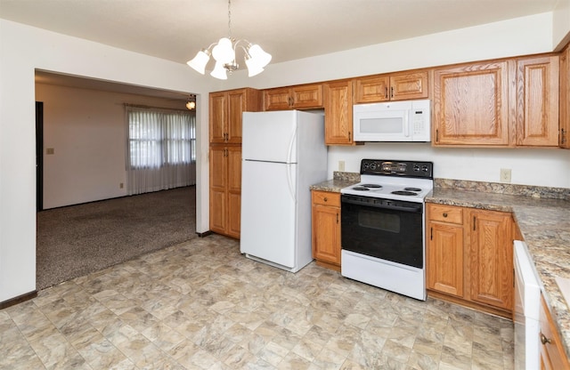 460 N 9th St, Carlisle, IA 50047 - kitchen featuring white appliances, a chandelier, brown cabinetry, and hanging light fixtures