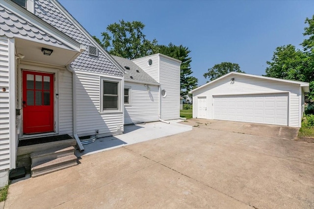 2325 61st St, Des Moines, IA 50322 - exterior space featuring entry steps, an outdoor structure, and a detached garage