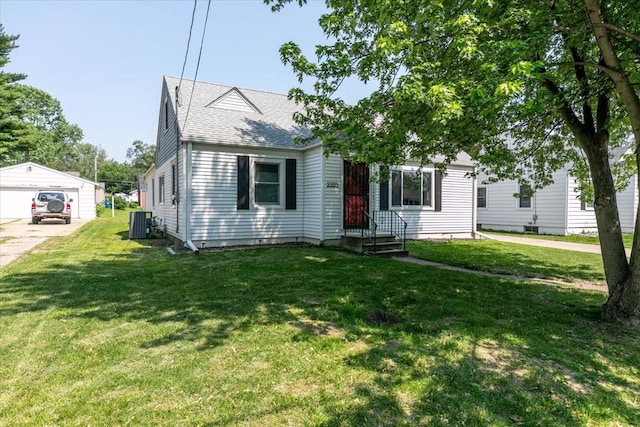 2325 61st St, Des Moines, IA 50322 - view of front of home featuring an outdoor structure, a front yard, and a garage