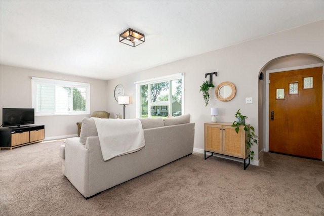 2325 61st St, Des Moines, IA 50322 - carpeted living area featuring arched walkways and plenty of natural light