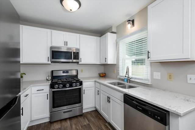 2325 61st St, Des Moines, IA 50322 - kitchen featuring appliances with stainless steel finishes, white cabinetry, and light stone countertops