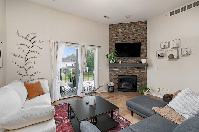6350 Coachlight Dr Unit 1308, West Des Moines, IA 50266 - living area featuring wood finished floors and a fireplace