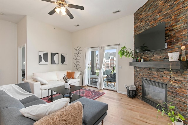 6350 Coachlight Dr Unit 1308, West Des Moines, IA 50266 - living room featuring wood finished floors, ceiling fan, and a fireplace