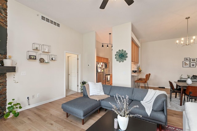 6350 Coachlight Dr Unit 1308, West Des Moines, IA 50266 - living area featuring light wood-type flooring, a ceiling fan, and a chandelier