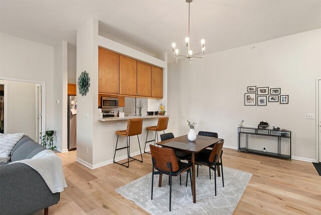 6350 Coachlight Dr Unit 1308, West Des Moines, IA 50266 - dining area featuring light wood-type flooring and a chandelier
