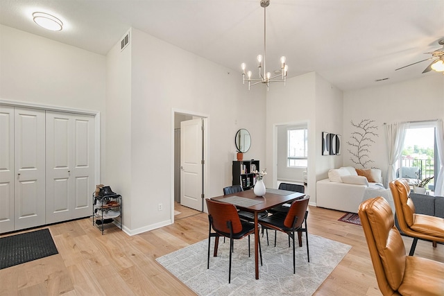 6350 Coachlight Dr Unit 1308, West Des Moines, IA 50266 - dining space with a high ceiling, healthy amount of natural light, light wood-style floors, a chandelier, and ceiling fan