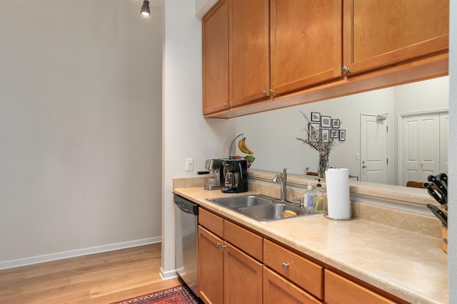 6350 Coachlight Dr Unit 1308, West Des Moines, IA 50266 - kitchen with stainless steel dishwasher, light countertops, light wood-type flooring, and brown cabinetry