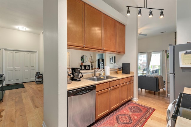 6350 Coachlight Dr Unit 1308, West Des Moines, IA 50266 - kitchen featuring appliances with stainless steel finishes, light wood finished floors, light countertops, brown cabinetry, and ceiling fan