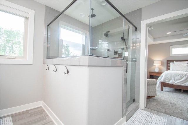 2416 NW Springbrooke Dr, Grimes, IA 50111 - ensuite bathroom featuring a stall shower, wood finished floors, and recessed lighting