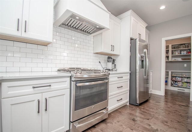 2416 NW Springbrooke Dr, Grimes, IA 50111 - kitchen featuring appliances with stainless steel finishes, wall chimney range hood, light countertops, white cabinets, and tasteful backsplash