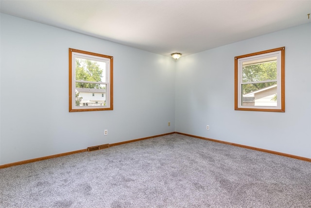 7013 Twana Dr, Urbandale, IA 50322 - spare room with plenty of natural light and carpet flooring