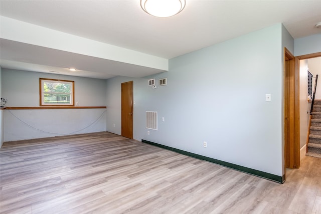 7013 Twana Dr, Urbandale, IA 50322 - spare room featuring light wood-style floors and stairway