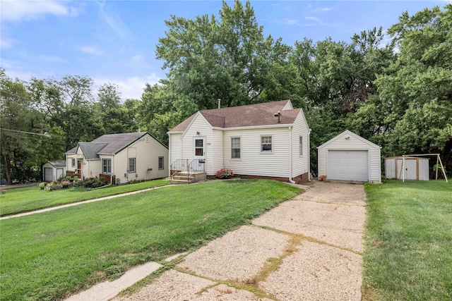 2326 Adams Ave, Des Moines, IA 50310 - view of front facade featuring concrete driveway, a garage, a front yard, a shed, and view of wooded area