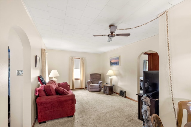 2326 Adams Ave, Des Moines, IA 50310 - carpeted living room with arched walkways and ceiling fan