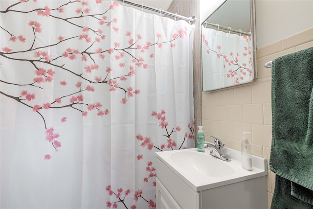 2326 Adams Ave, Des Moines, IA 50310 - bathroom featuring tile walls, vanity, a shower with shower curtain, and backsplash