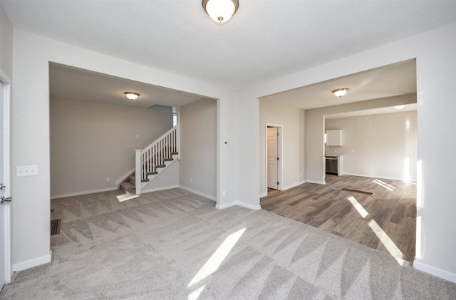 1332 E Sheridan Ave, Des Moines, IA 50316 - carpeted spare room with stairway and baseboards