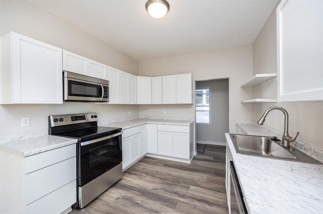 1332 E Sheridan Ave, Des Moines, IA 50316 - kitchen featuring stainless steel appliances, open shelves, white cabinets, and wood finished floors