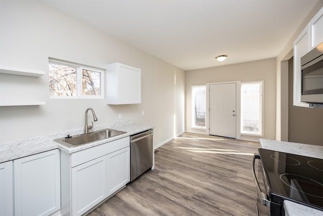 1332 E Sheridan Ave, Des Moines, IA 50316 - kitchen featuring appliances with stainless steel finishes, white cabinets, open shelves, wood finished floors, and light stone counters