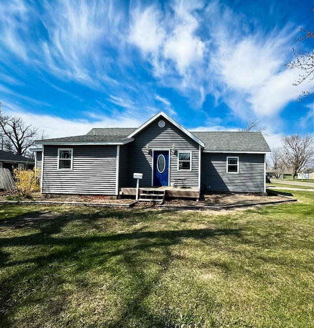 1533 Spencer St, Grinnell, IA 50112 - rear view of house with a lawn and roof with shingles