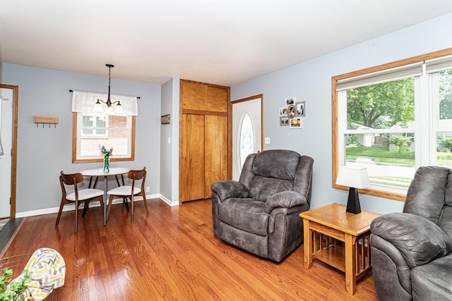1621 Carroll Ave, Ames, IA 50010 - living room with a chandelier and light wood-style floors