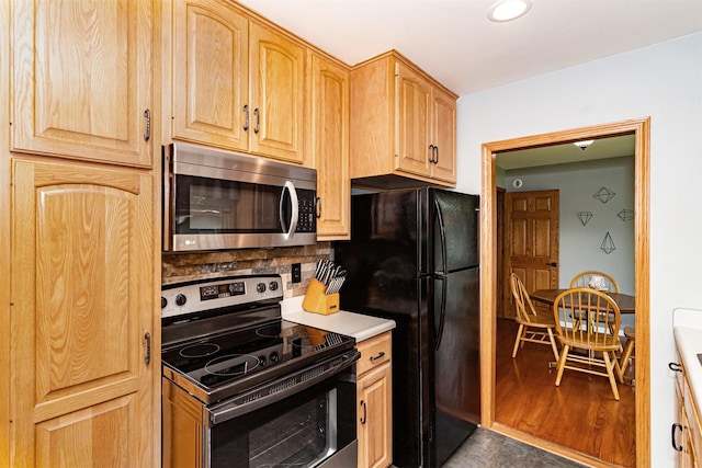 1621 Carroll Ave, Ames, IA 50010 - kitchen with stainless steel appliances, light brown cabinets, tasteful backsplash, wood finished floors, and recessed lighting