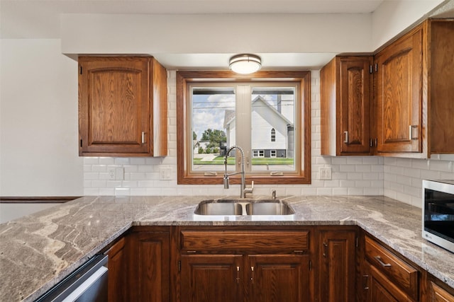 506 2nd Ave SW, Altoona, IA 50009 - kitchen with stainless steel appliances, backsplash, and light stone counters