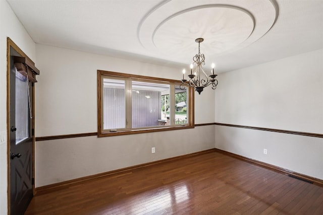 506 2nd Ave SW, Altoona, IA 50009 - spare room featuring wood-type flooring and a chandelier