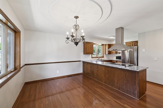 506 2nd Ave SW, Altoona, IA 50009 - kitchen featuring appliances with stainless steel finishes, island exhaust hood, a peninsula, and dark wood-type flooring