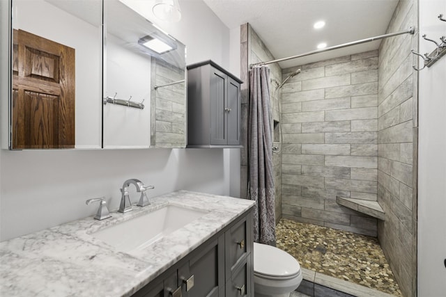 506 2nd Ave SW, Altoona, IA 50009 - bathroom featuring vanity, a tile shower, and recessed lighting